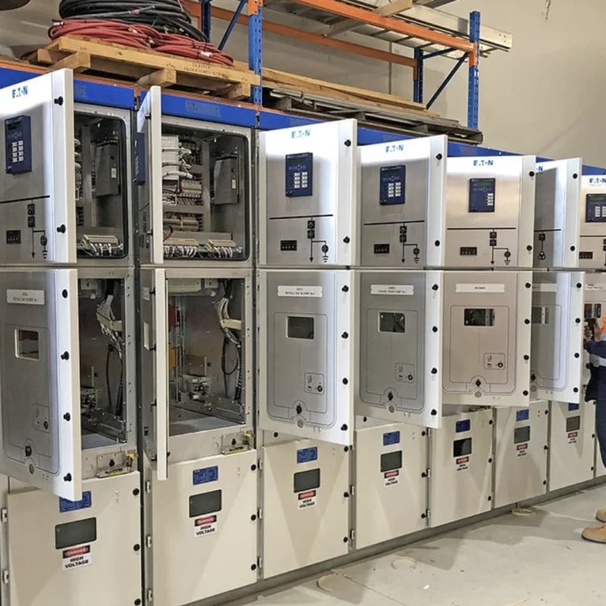 Technician-working-on-a-medium-voltage-system-in-a-factory